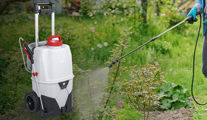 A person using battery-powered sprayer to spray a flower garden